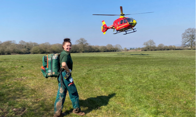 Sophie Bassi posing with air ambulance in the background