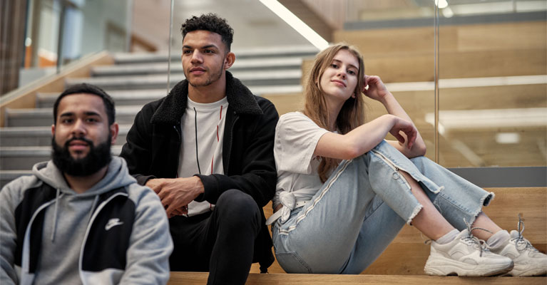 Male and female students sitting together