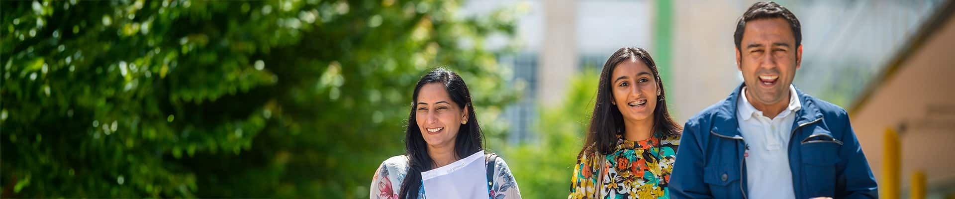 Student and her parents walking through Coventry on a sunny day