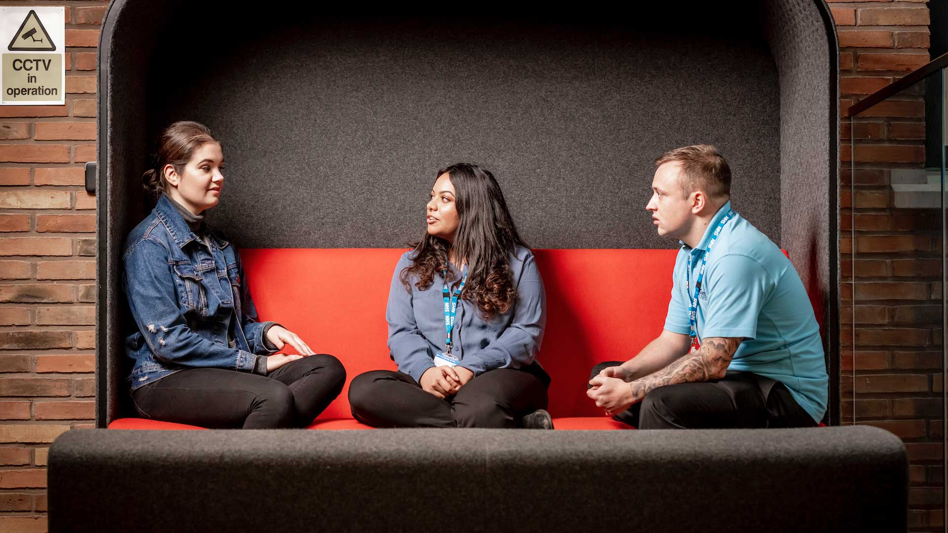 Two women sat on a sofa chatting