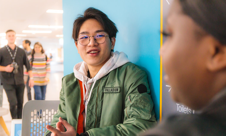 Keith Choi chatting with another student at the CU Coventry campus