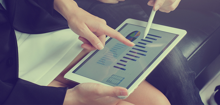 Soemones hand and another persons pen pointing at a graph on a tablet screen