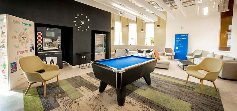 Pool table and chairs in an open area inside Bishop Gate