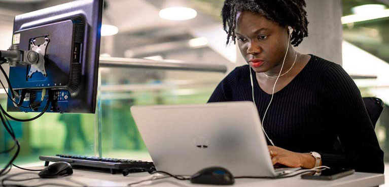 A student intently looking at a laptop