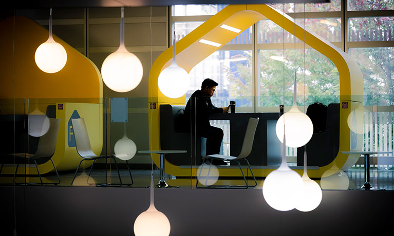 Student working at a desk in the hub 