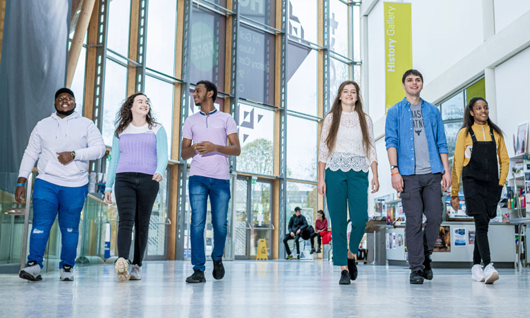 A group of students walking through the Herbert Art Gallery and Museum in Coventry.