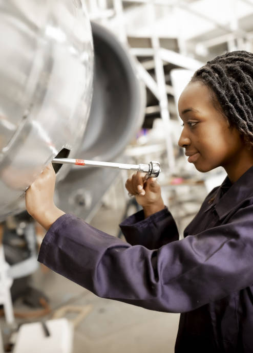 a woman working on a airplane in a Coventry University engineering building