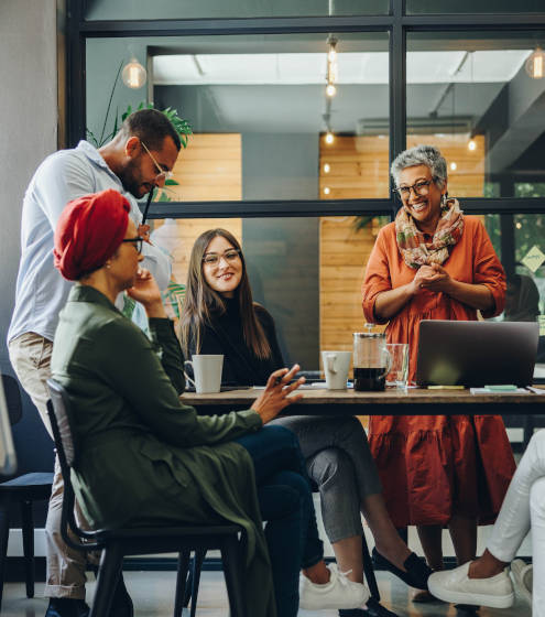 Group of people sitting and talking around the table