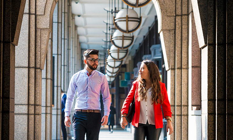 Two students walking on the Coventry University London campus.