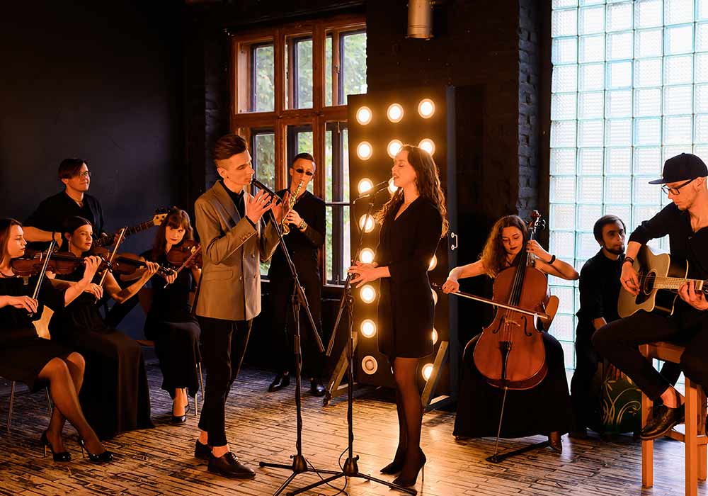 female singer with an orchestral band playing