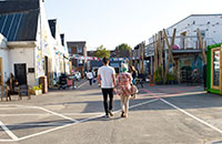 male and female walking into Fargo villiage