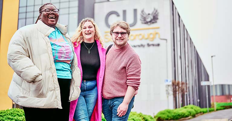 Three students stood outside of the CU Scarborough campus building