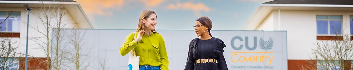 Two students walking outside of CU Coventry