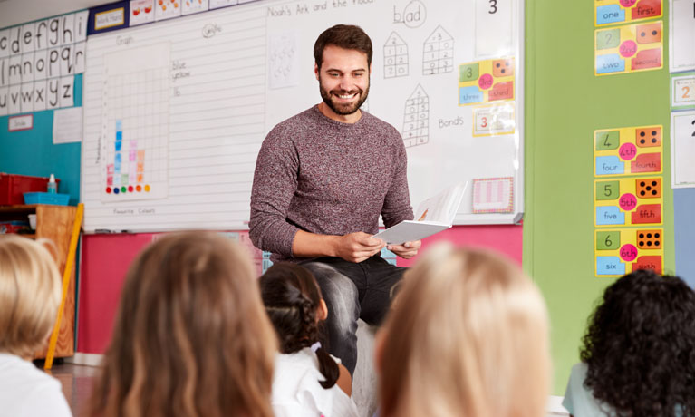 Male teacher talking to class.