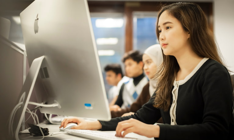 Group of students sat at computers